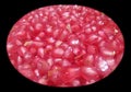 Pomegranate seeds isolated from black round vignettes frame, food photography, healthy fruits