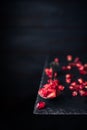 pomegranate seeds on an old vintage spoon isolated on stone table. copy space for text. vintage style Royalty Free Stock Photo