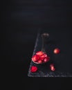 pomegranate seeds on an old vintage spoon isolated on stone table. copy space for text. vintage style Royalty Free Stock Photo