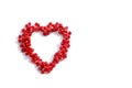 Pomegranate seeds scattered in the shape of a heart on white background. love concept