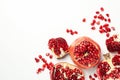 Pomegranate and seeds on white background