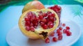 Pomegranate seeds on white plate, tropical fruit sweet and good for health. Organic fruit high vitamin and mineral. Royalty Free Stock Photo