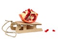 Pomegranate on a sled on white background. Royalty Free Stock Photo