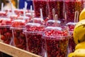 Pomegranate and strawberry plastic glasses Royalty Free Stock Photo