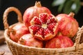 Pomegranates in Basket with Open Seed Cluster Royalty Free Stock Photo