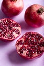 Pomegranates cut open with pomegrante seeds. Fruit minimalism creative concept Royalty Free Stock Photo