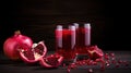 Pomegranates and pomegranate juice on a wooden table. Whole fruits and pieces. Dark background. Copy space.