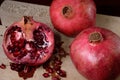 Pomegranates on wooden cutting board Cut fruit with seeds