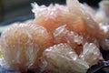 Pomelo fruit peeled closeup on plate. Grapefruit, jeruk Bali, or Bali pomelo fruit.