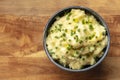 Pomme puree, a bowl of mashed potatoes with scallions and thyme