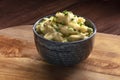 Pomme puree, a photo of a bowl of mashed potatoes with herbs on a rustic background