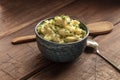 Pomme puree, a photo of a bowl of mashed potatoes with herbs on a rustic background with a wooden spoon