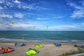 Kitesurfers surfing the wind on waves on a bright sunny summer day