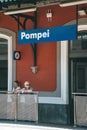 Pompei, Italy - August 10, 2019: City name of Pompei with tourists below in train staion of Pompei