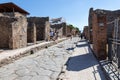 Pompeii, Company, Italy - June 25, 2019: typical street of ancient Pompeii. Tourists visit the ruins of the ancient Roman city of