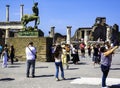 Pompeii excavations: tourists admire a bronze statue