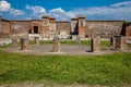 Girl visiting the ruins of the Macellum in the ancient city of Pompeii in a beautiful early spring