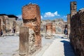 Tourists visiting the ruins of the houses of the ancient city of Pompeii