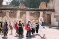 Pompeii, Italy. Group Of Schoolchildren Walking On Excursions Near Remains Of Ancient Building In Sunny Day