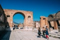 Pompeii, Italy. Group Of Tourists Walking Near Remains Of Ancient Building In Sunny Day