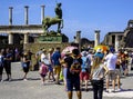 Pompeii excavations: tourists admire a bronze statue