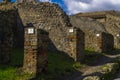 Pompeii, Italy Roman architecture city block remains with numbered homes entrances. Royalty Free Stock Photo