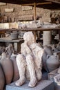 Pompeii, Naples, Italy: body cast of a victim of the eruption of Vesuvius, stored in the Granaries of the Forum