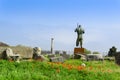 Pompeii ruins and bronze statue of Daedalus among poppies and green grass