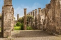 Pompeii ruins: a yard and destroyed stone columns at archeological site