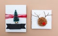 Pompom reindeer and miniature Christmas tree gift boxes on brown Royalty Free Stock Photo