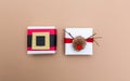 Pompom reindeer and santa belt gift boxes on brown paper