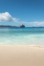 Ponant cruise ship at the beach of Aride Island, Seychelles. Royalty Free Stock Photo