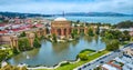 Pond around open rotunda and colonnade of Palace of Fine Arts with Golden Gate Bridge aerial