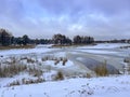 A pond covered with ice and covered with snow in Kalety Zielona, Poland. Visible windmill on the island Royalty Free Stock Photo