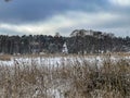 A pond covered with ice and covered with snow in Kalety Zielona, Poland. Visible windmill on the island Royalty Free Stock Photo