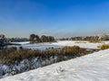 A pond covered with ice and covered with snow in Kalety Zielona, Poland. Visible windmill on the island Royalty Free Stock Photo