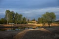 A pond excavated in the city. Water and shore. The lake at sunset Royalty Free Stock Photo