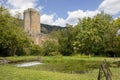 A pond of the Garden of Ninfa in Italy in the province of Latina and the medieval tower on the background.