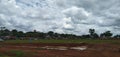 Pond and green grass rain clouds and man