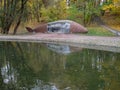 Pond or lake at park in autumn. Place for fishing