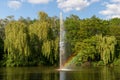 Pond, lake in the park, nature reserve, recreational area with fountain in the middle and with beautiful green trees in the backgr Royalty Free Stock Photo