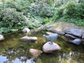 Pond with reflection. statue, blooming bushes in the park, in Kotka, Finland