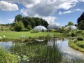 Pond or Teich and Tropenhaus - Botanical Garden of the University of Zurich or Botanischer Garten der Universitaet Zuerich Royalty Free Stock Photo