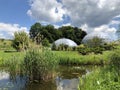 Pond or Teich and Tropenhaus - Botanical Garden of the University of Zurich or Botanischer Garten der Universitaet Zuerich Royalty Free Stock Photo