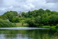 Pond and traditional house near the Admissions Hut into  Lyme Park, Disley in Cheshire, UK Royalty Free Stock Photo
