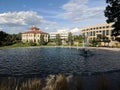 Manmade pond with water fountains and buildings