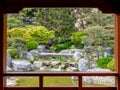 A pond and a waterfall seen from a wood pavilion of the Japanese garden of Monaco Royalty Free Stock Photo
