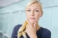 Pondering her next career move. Portrait of an attractive young blonde woman standing in an office and thinking about Royalty Free Stock Photo