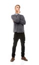 Pondering his fashion sense. Full length studio shot of a young man looking thoughtful isolated on white. Royalty Free Stock Photo