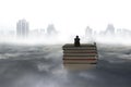 Pondering man sitting on stack of books with cityscape cloudscape Royalty Free Stock Photo